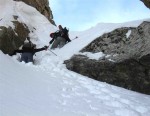 Dustin offers a ski pole in the loose snow at the top